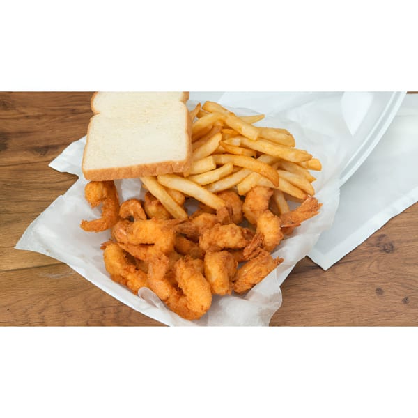 Fried shrimp and french fries with a slice of white bread in a takeout container.